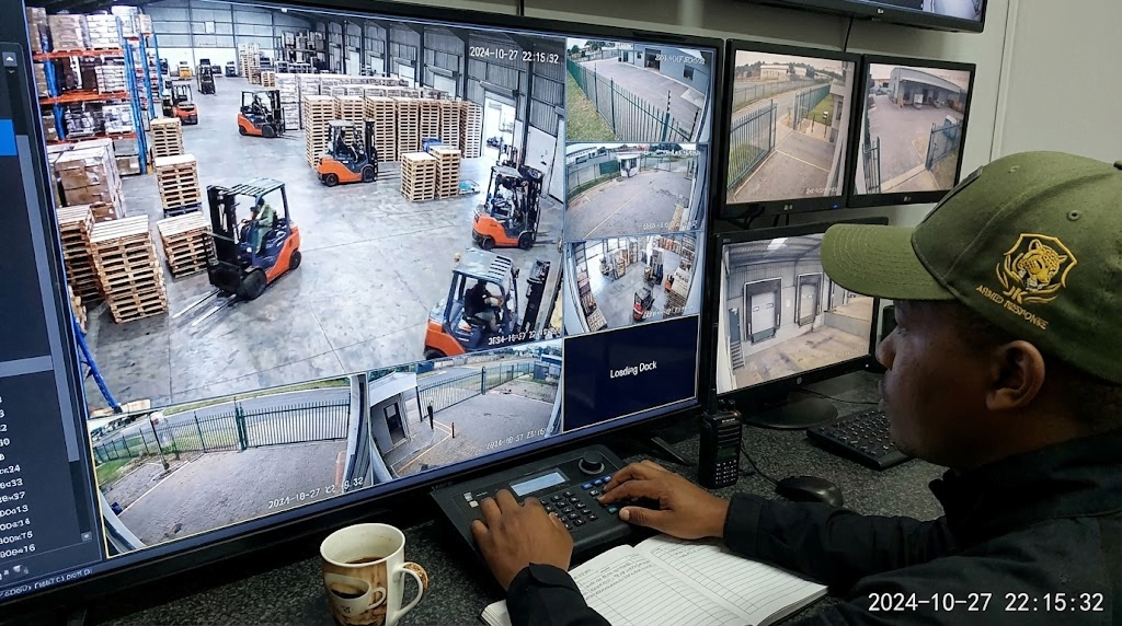 JK Armed Response off-site monitoring control room operator analyzing live video feeds for security threats.